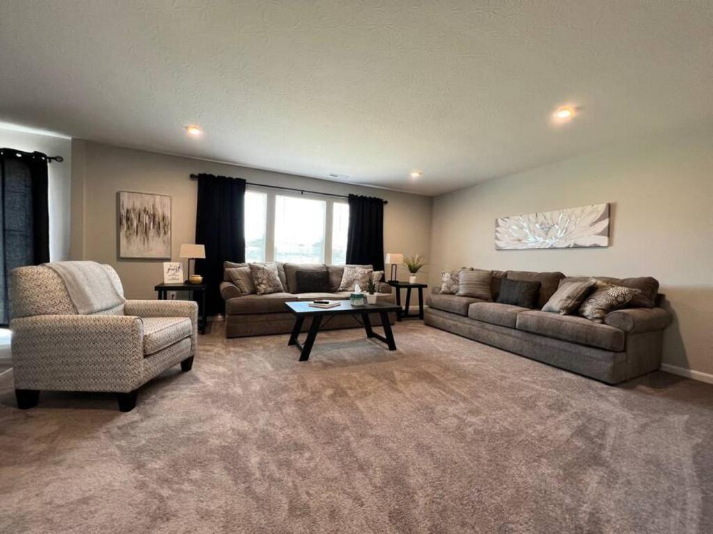 a living room with two couches and a coffee table at 7876 Ellington Court Cheerful 4 Bedroom Home Brand New Construction in Maineville