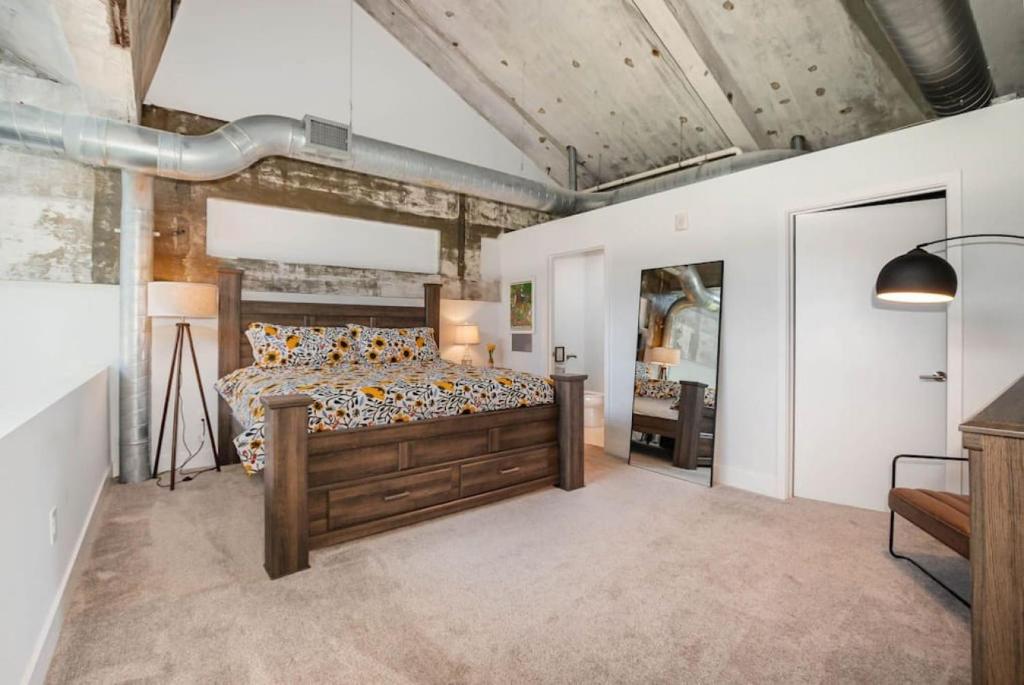 a bedroom with a wooden bed and a mirror at 5103 Peters New Industrial Loft on Lebanon Bike Trail in Maineville