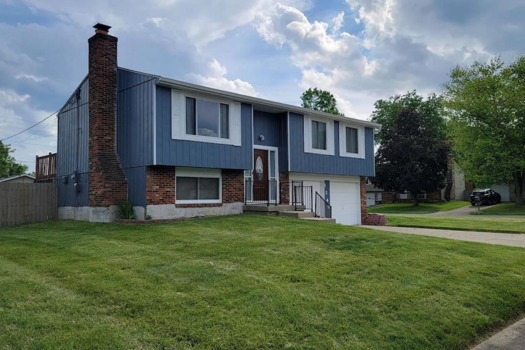 a house with a blue roof and a grass yard at 1349 Jennings court Private Pool, Fire pit, BBQ A FUN place to RELAX in Mason