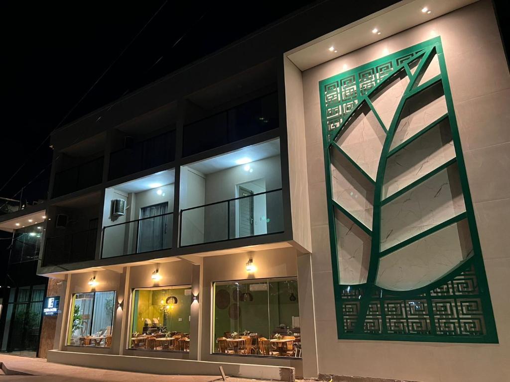 a building with a green sign on the side of it at HOTEL TERRA NATIVA in Alter do Chao