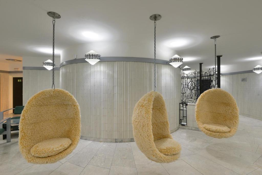 three furry chairs in a room with a table at Hotel Ještěd in Liberec