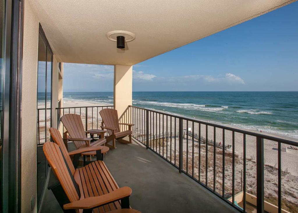 a balcony with chairs and a view of the beach at Phoenix II 2067 in Orange Beach