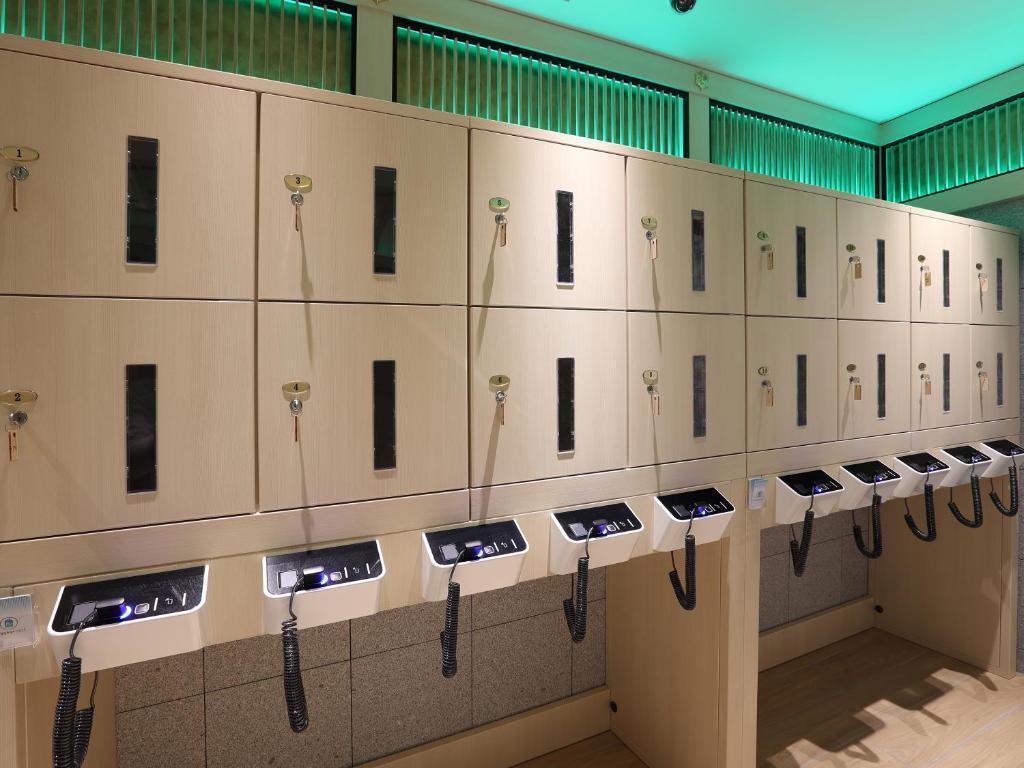 a row of lockers lined up in a room at Henn na Hotel Premier Nagoya Fushimiekimae in Nagoya