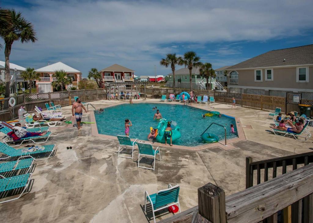 a group of people in a pool at a resort at Poseidon Palace in Sand Landing