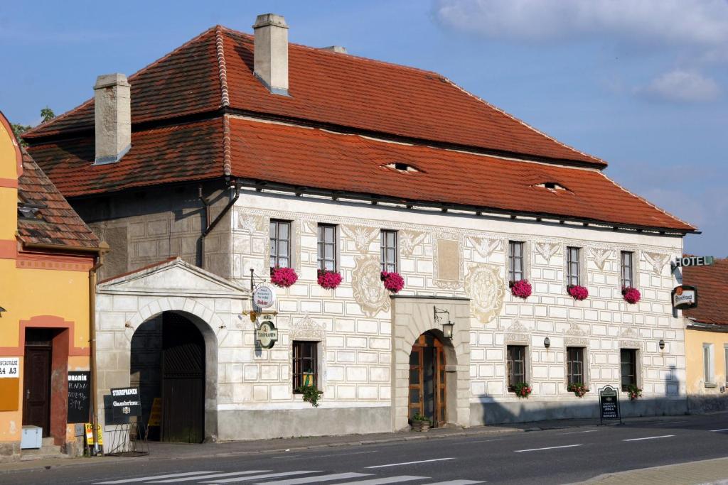 a large white building with a red roof at Hotel Na Velké hospodě in Sedlice