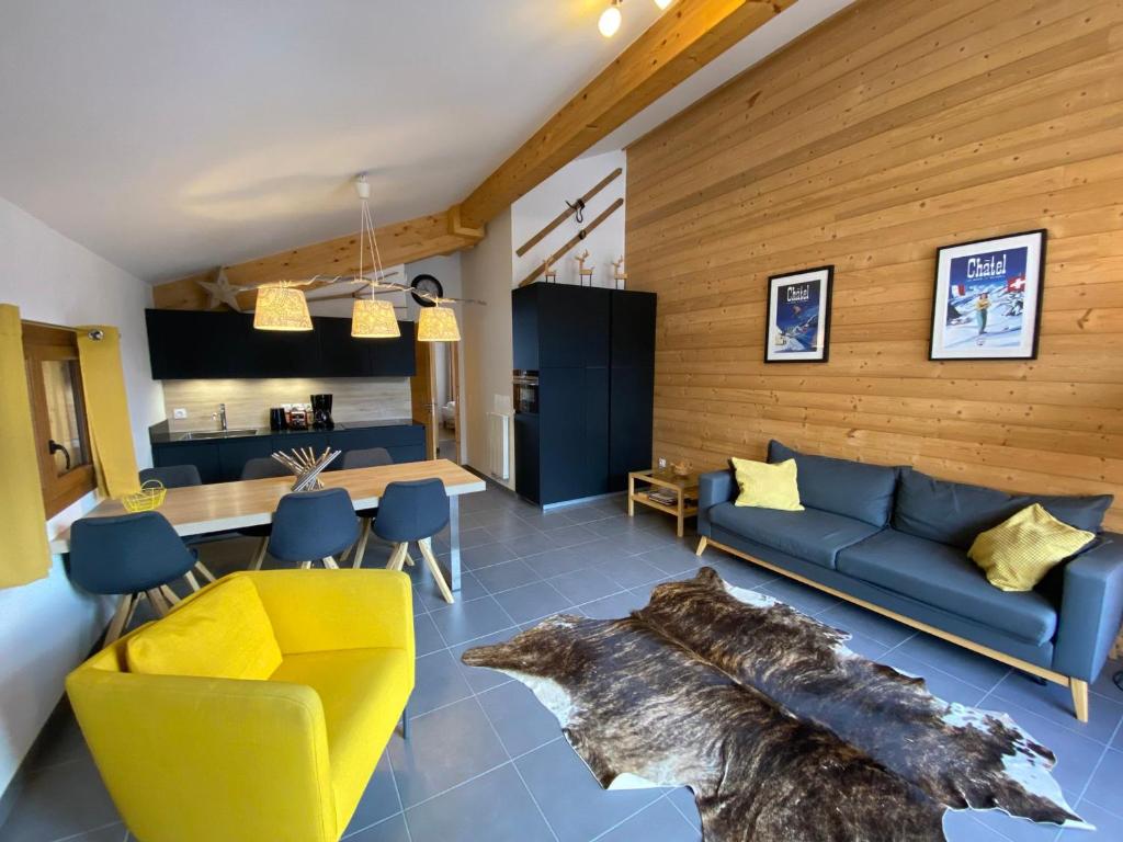 un salon avec un canapé bleu et un grand tapis à motifs animaliers dans l'établissement Appartement Châtel, 3 pièces, 6 personnes - FR-1-693-33, à Châtel