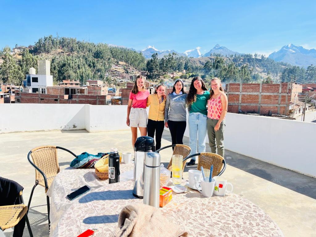 a group of people standing on top of a roof at Montañero Hostel in Huaraz