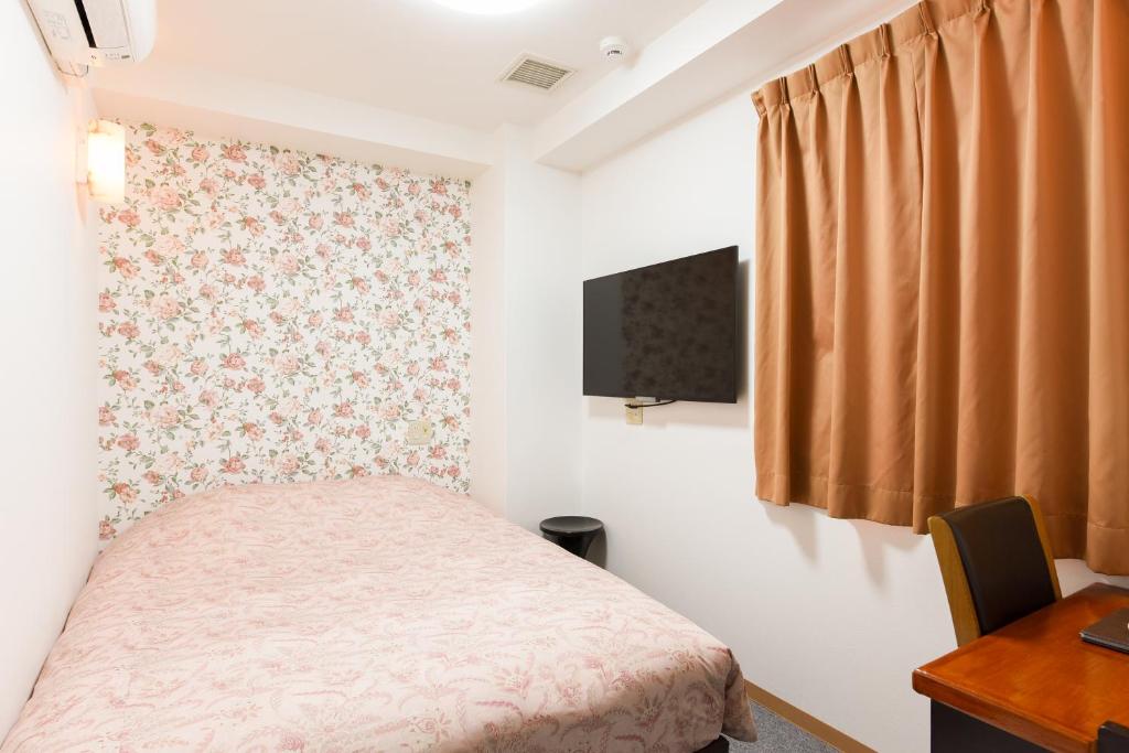 TV a/nebo společenská místnost v ubytování Otsuka Town Hotel