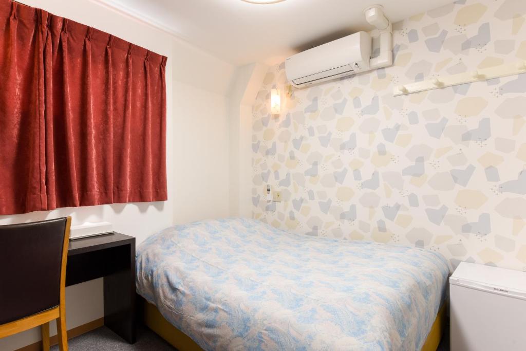 Postel nebo postele na pokoji v ubytování Otsuka Town Hotel