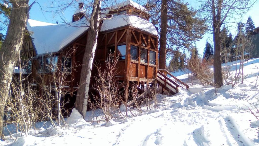 a log cabin with snow on it in the woods at Close to the Lake, Peaceful 5 Bedroom #343 in Tamarack