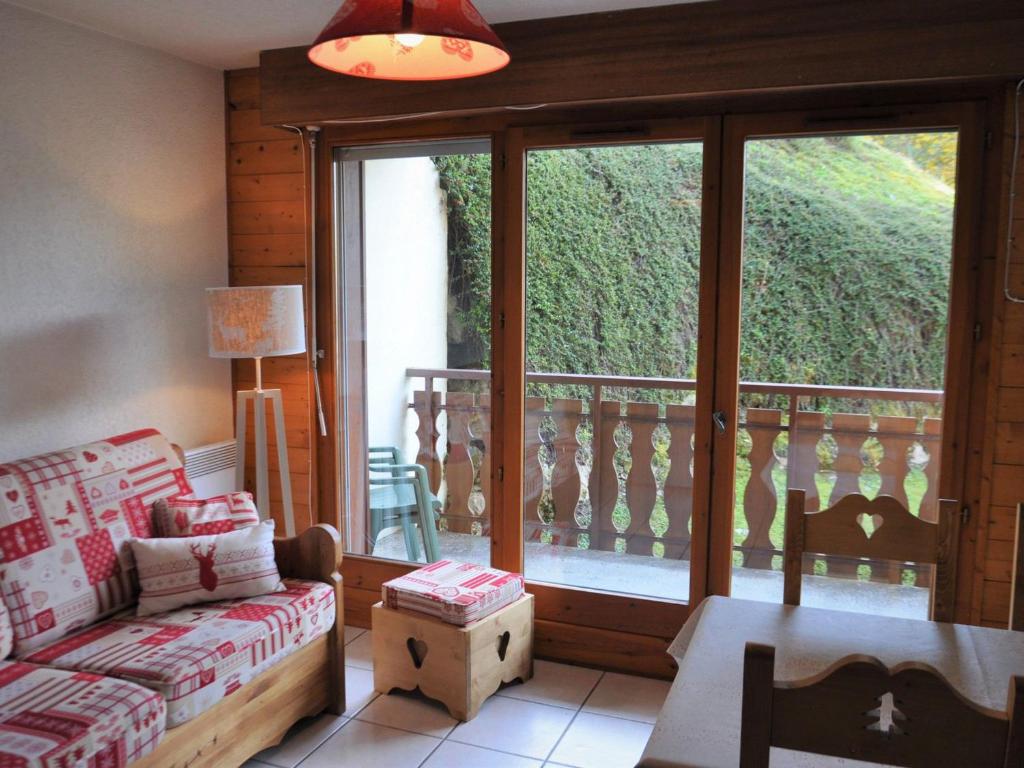a living room with a couch and a balcony at Appartement Châtel, 2 pièces, 5 personnes - FR-1-693-77 in Châtel