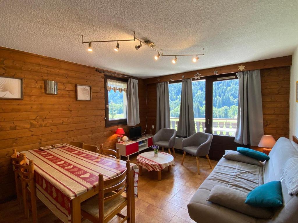 a living room with a couch and a table at Appartement La Chapelle-d'Abondance, 2 pièces, 6 personnes - FR-1-692-23 in La Chapelle-dʼAbondance