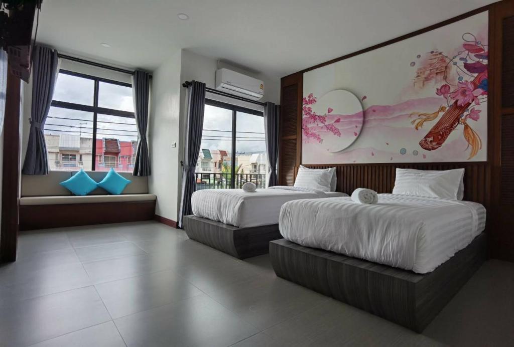 Postel nebo postele na pokoji v ubytování โรงแรมชลาลัย กระบี่ Chalalai Hotel Krabi