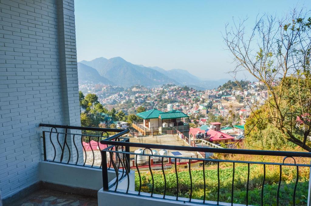 a balcony with a view of a city at Three bedroom house with private garden in Solan