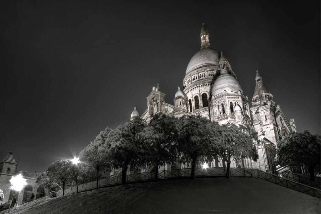 a black and white photo of a building at night at Hotel Boronali in Paris