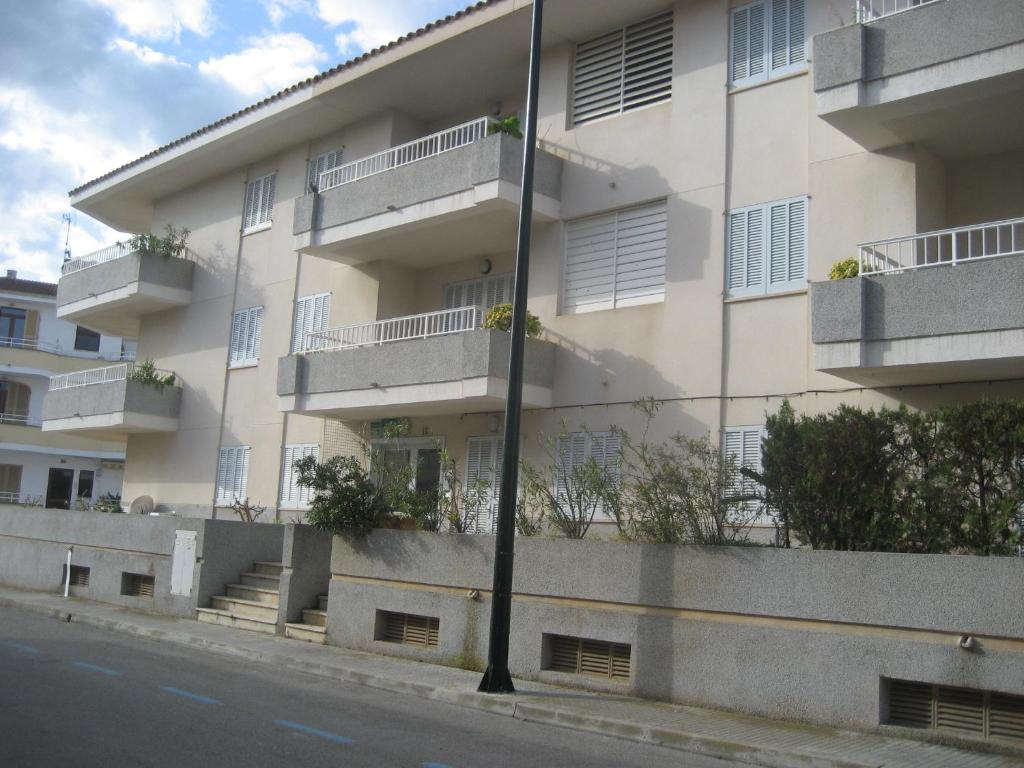 a building with balconies on the side of a street at Holiday homes Bonamar in Colònia de Sant Jordi