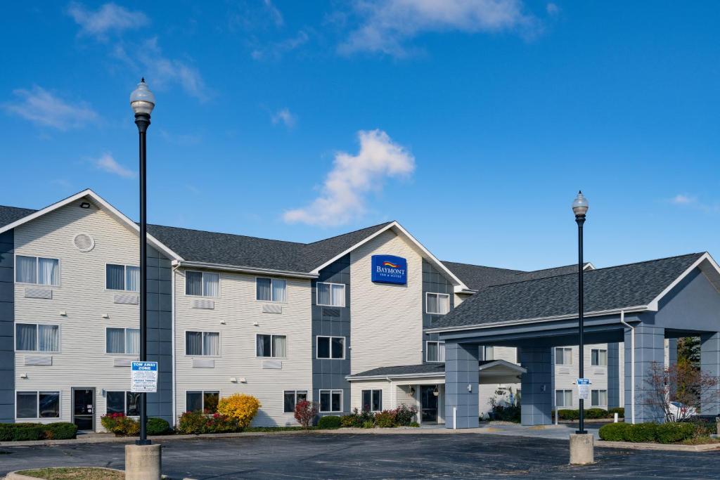 a large white building with a blue sign on it at Baymont by Wyndham Gurnee in Gurnee