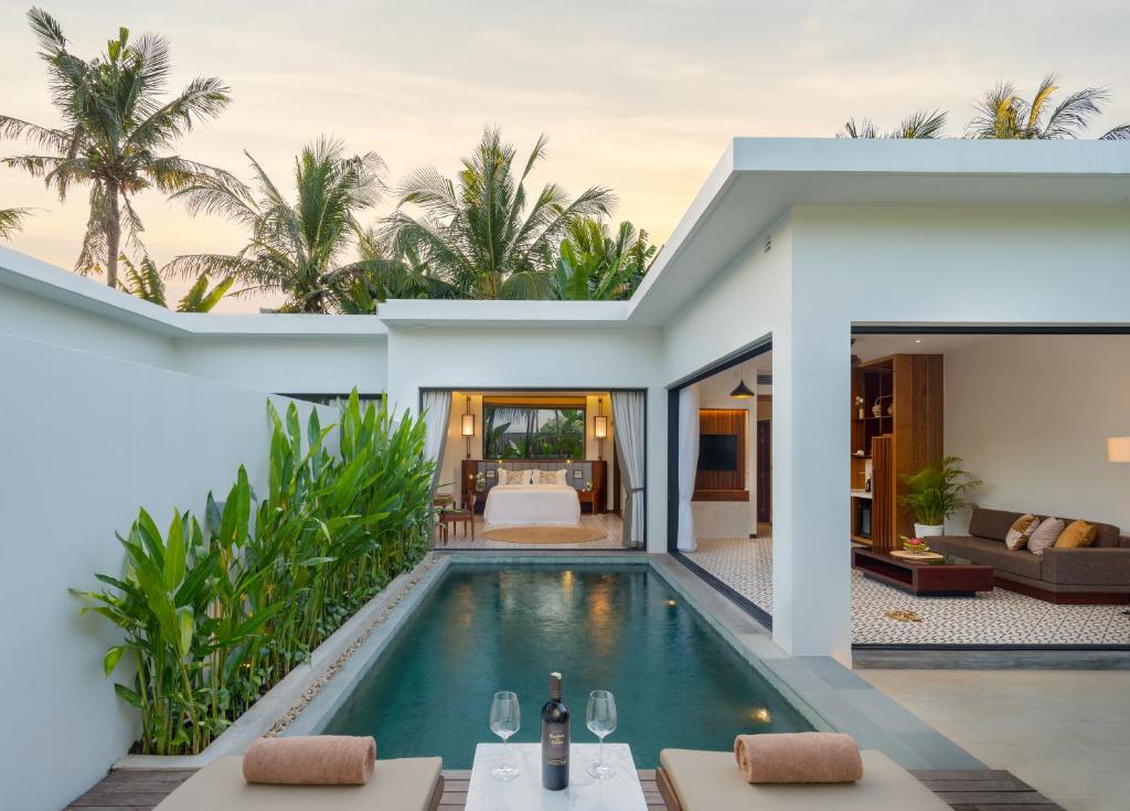 a villa with a swimming pool and a bedroom at WAKA VILLA Private Resort & Spa - Adults Only in Siem Reap