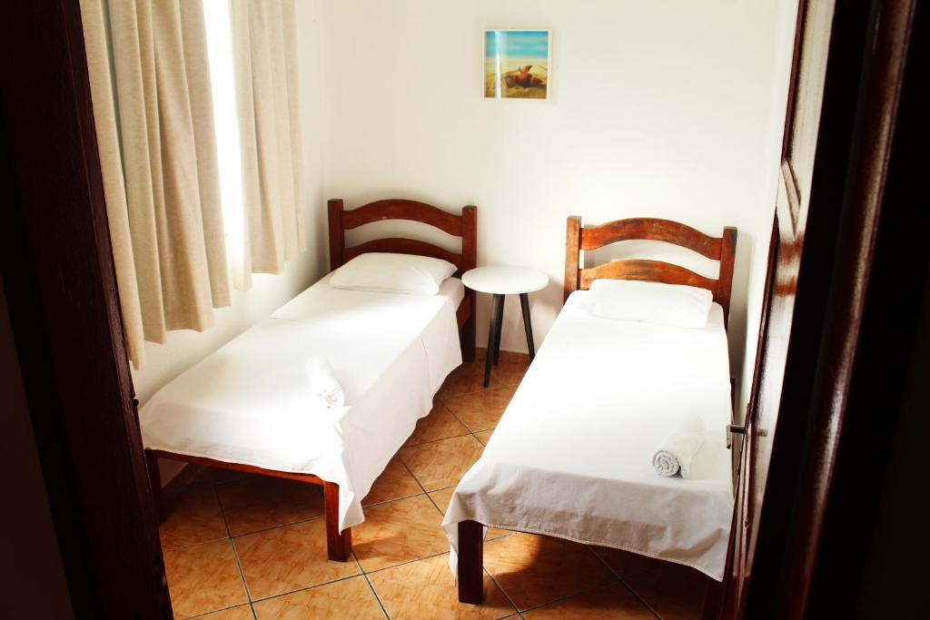 Postel nebo postele na pokoji v ubytování Tamboleiro's Hotel Residence