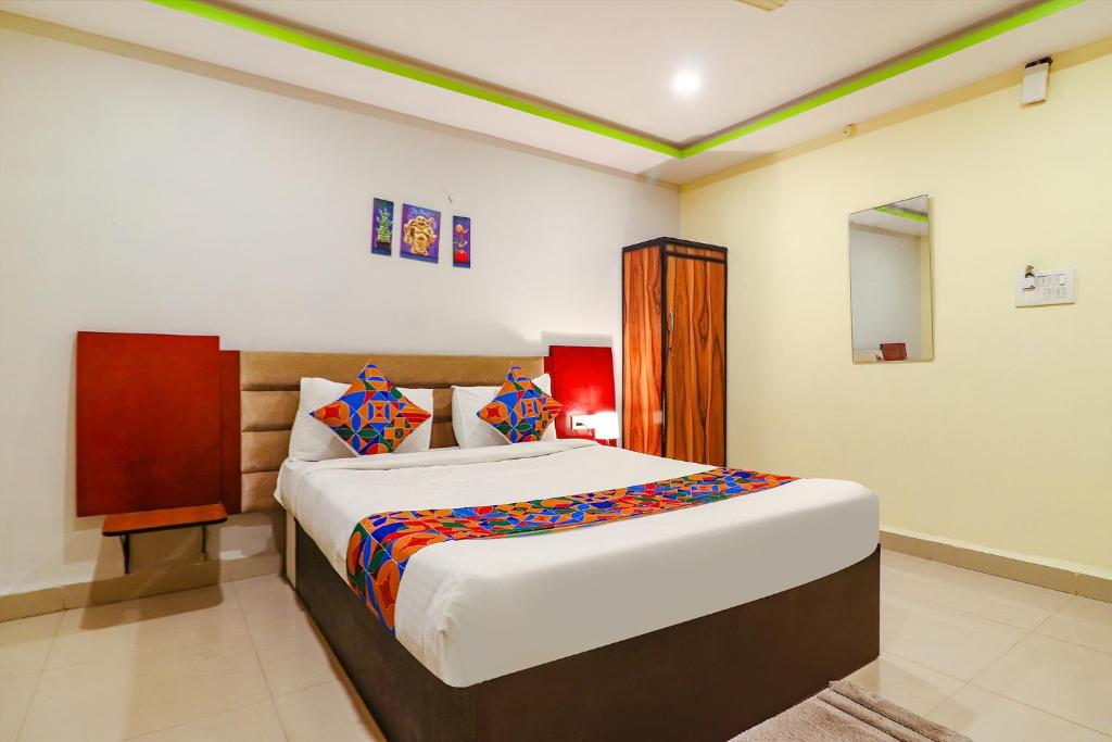 a bedroom with a large bed in a room at FabExpress Broholic Suites in Hyderabad
