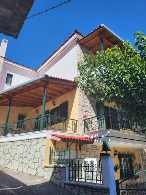 a large building with a fence in front of it at Παραδοσιακό Αρχοντικό με Τζάκι in Valtessiniko 