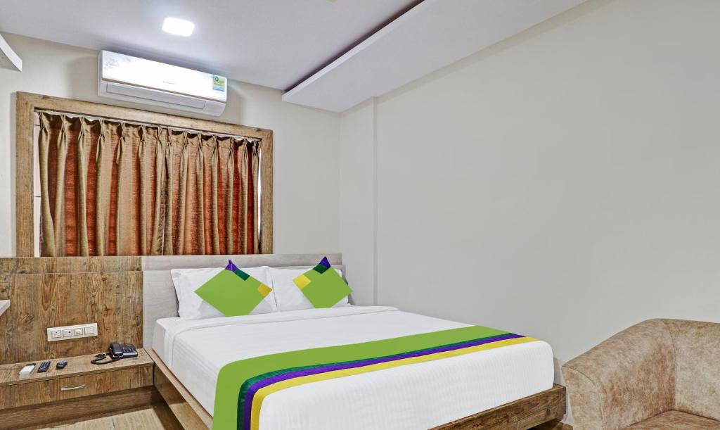 a bedroom with a bed and a window at Treebo Trend Zion in Bangalore