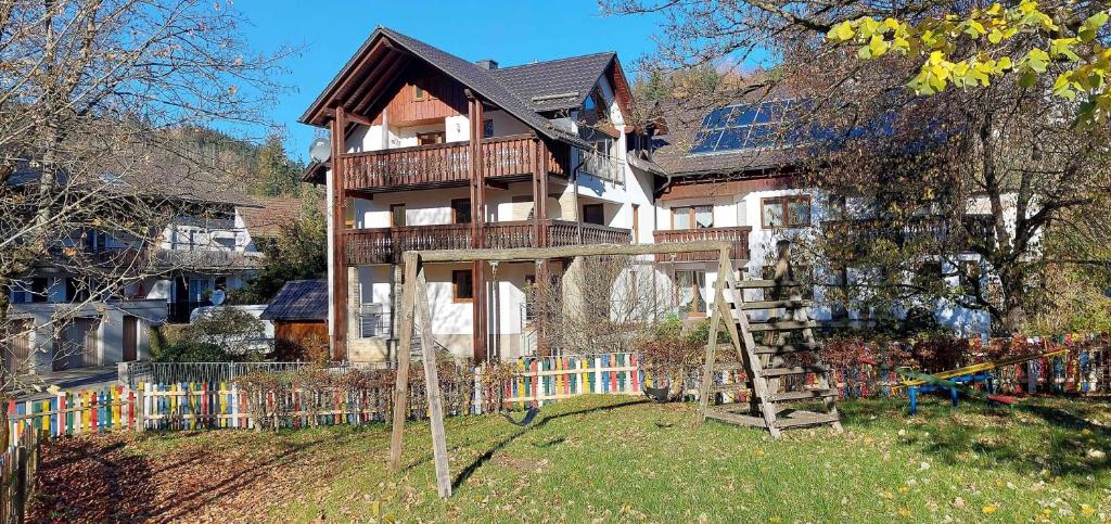 a large house with a staircase in front of it at Ferienwohnung Ebert in Steinwiesen