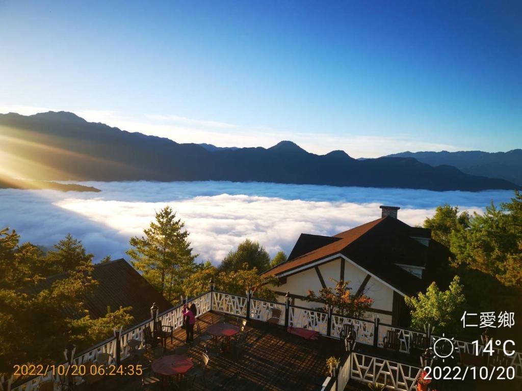 a building with a view of the clouds and mountains at Naluwan Villa in Ren&#39;ai