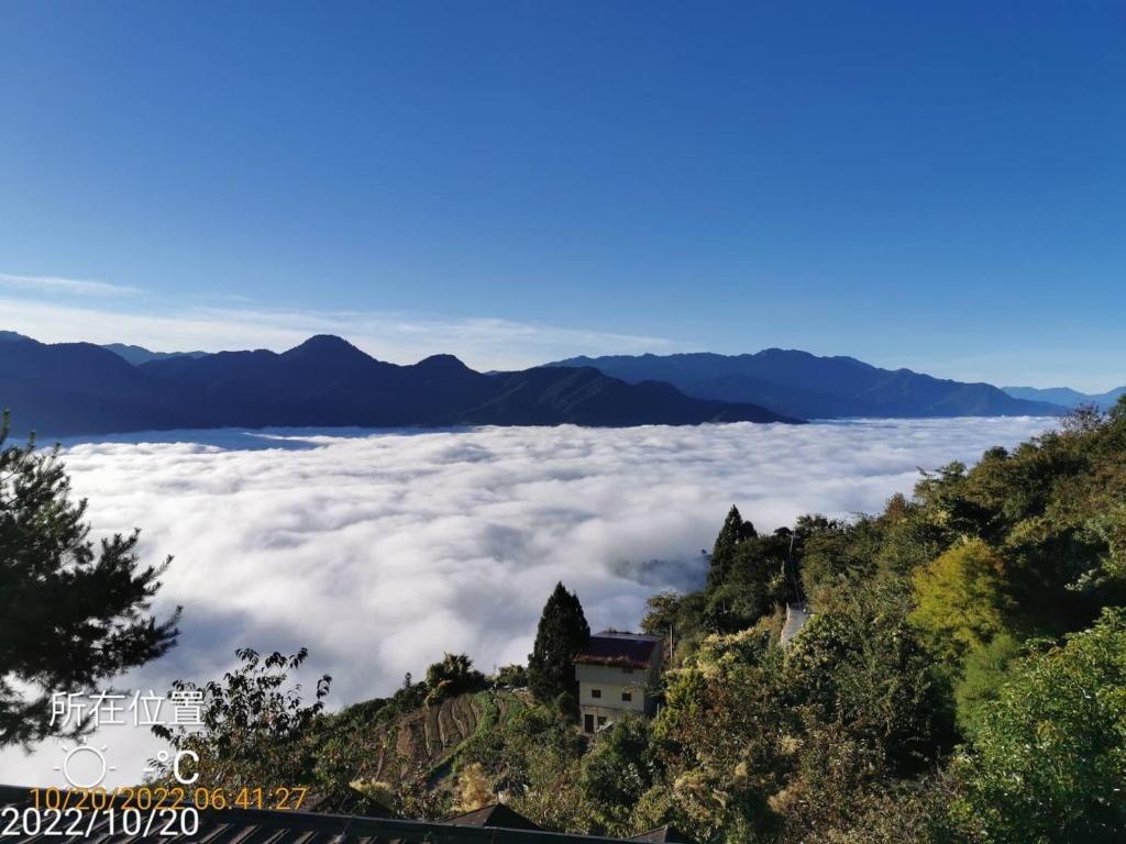 a view from the top of a mountain with clouds at Naluwan Villa in Ren&#39;ai