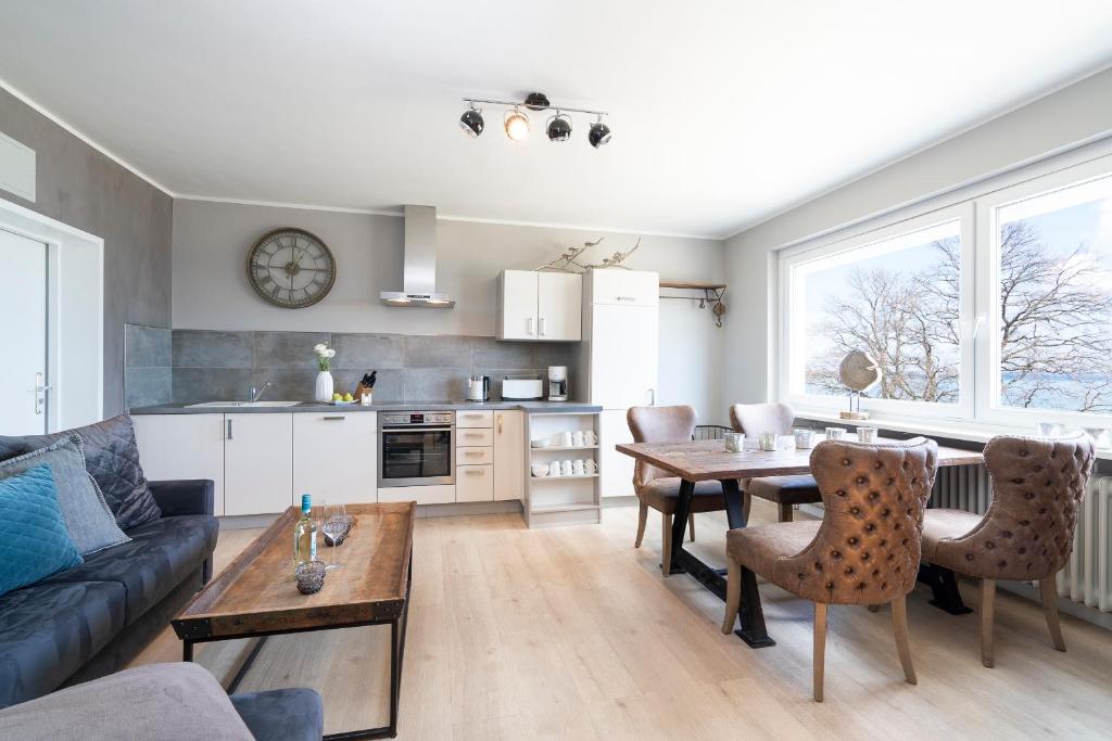ein Wohnzimmer mit einem Tisch und einer Küche in der Unterkunft Ferienwohnung Puro Suite in Scharbeutz
