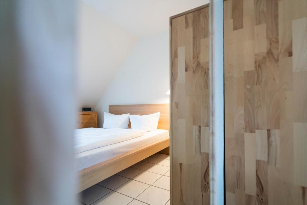 Postel nebo postele na pokoji v ubytování Wohnpark am Mühlenteich - Appartement 24