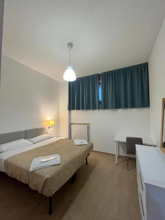 a hotel room with two beds and a window at Rucellai Guest House in Milan