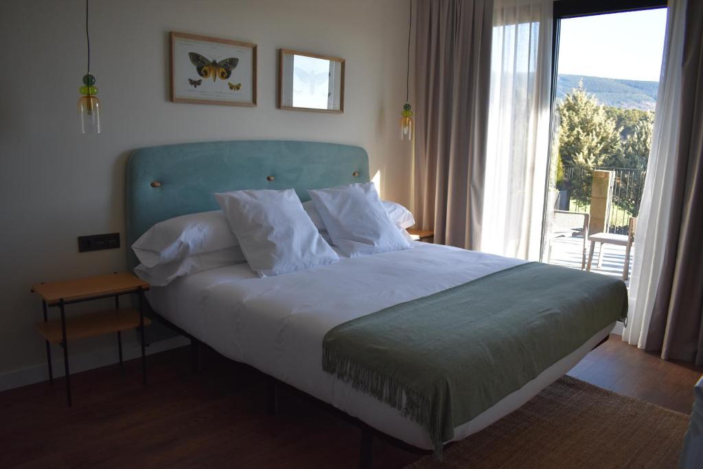 Posteľ alebo postele v izbe v ubytovaní Duruelo Mountain Suites