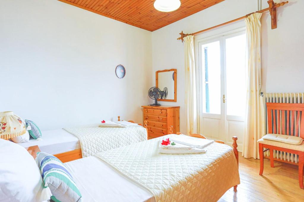 Postel nebo postele na pokoji v ubytování Agathi House