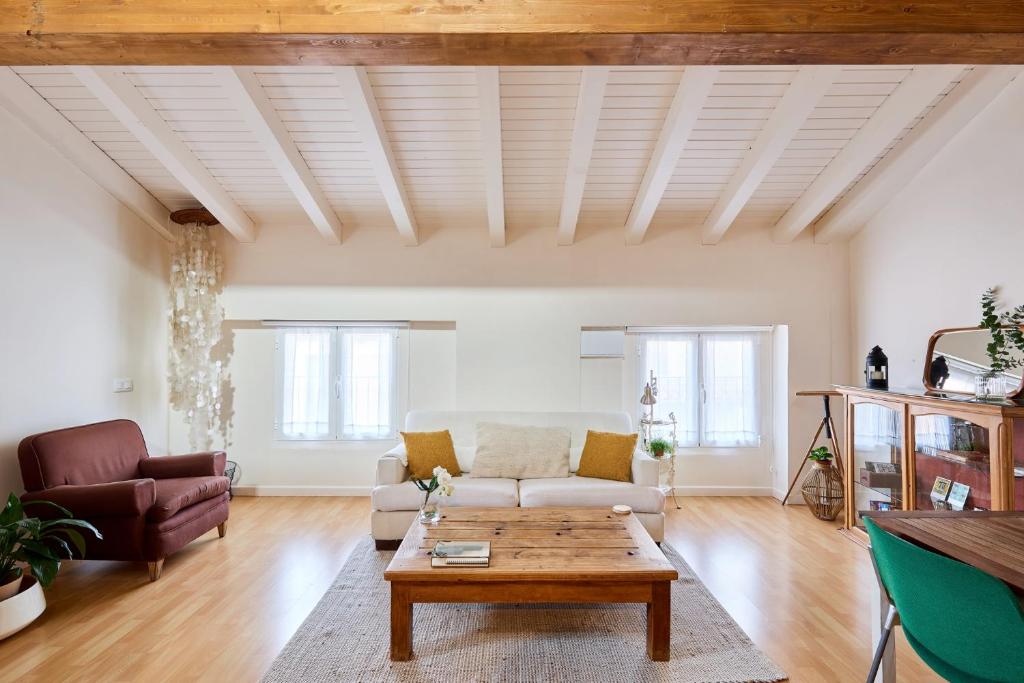 a living room with a couch and a coffee table at Atico vistas Estafeta,centro historico in Pamplona