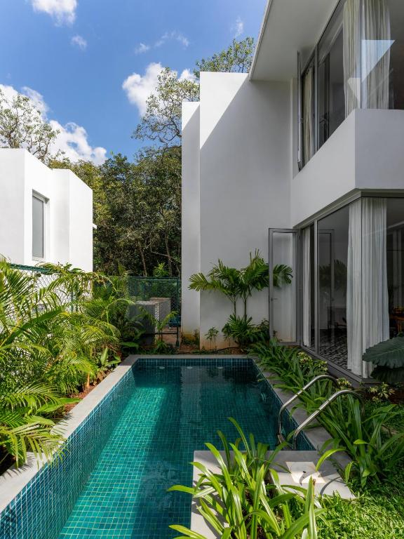 a swimming pool in the backyard of a house at La Avila by The Blue Kite - 2 BHK Villas near Morjim Beach & Thalassa with Private Pool, Kitchen, Balcony & Security in Siolim