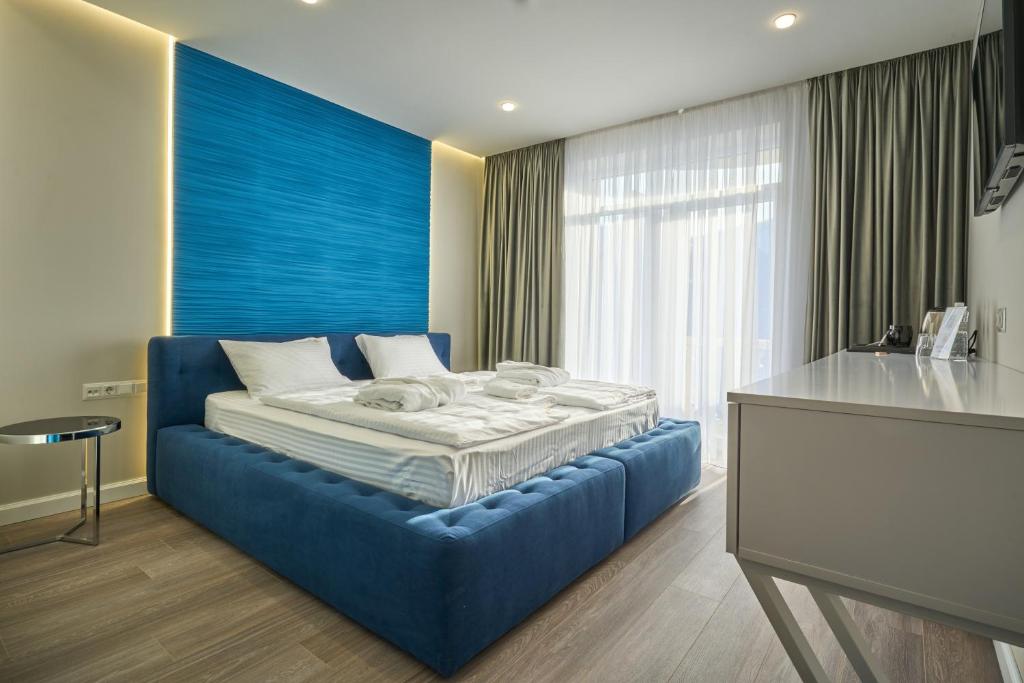 Postel nebo postele na pokoji v ubytování Olimp Hotel