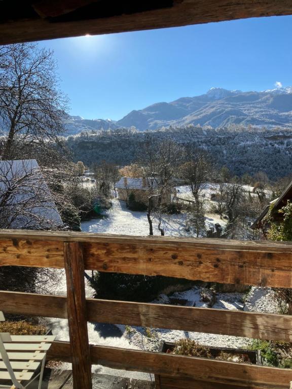 a view of a river from a porch with snow on the ground at Chambre d'hôtes La Font in Eygliers