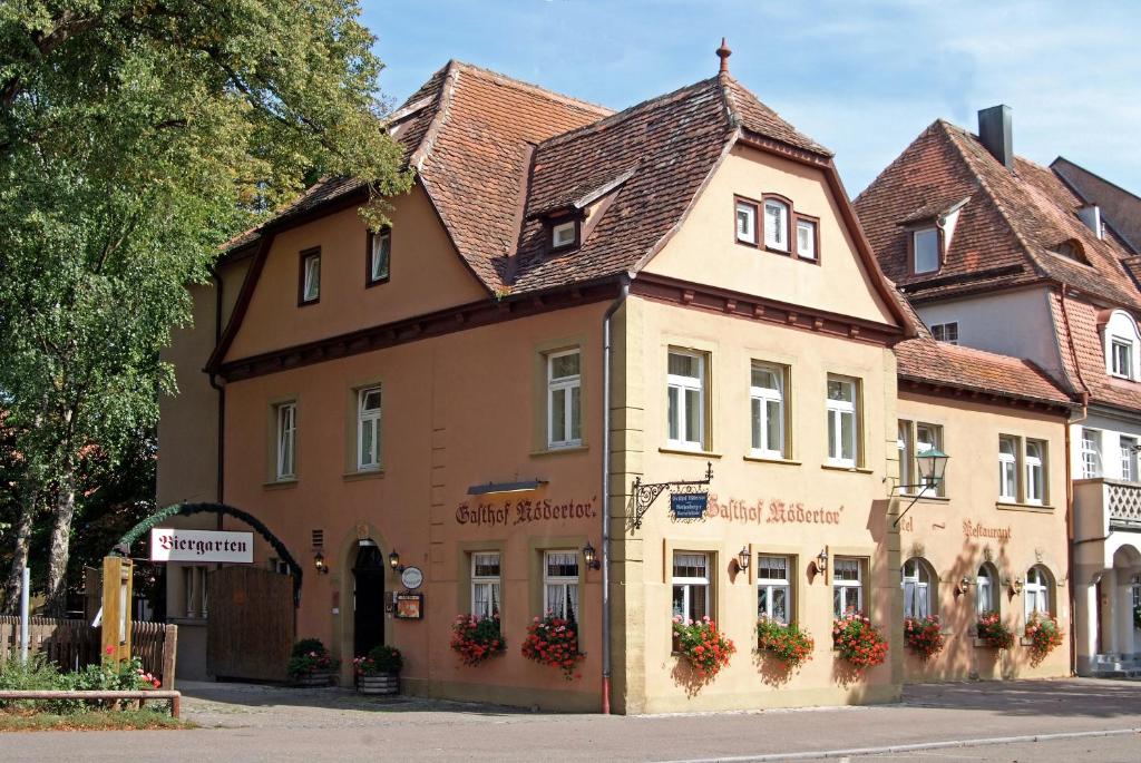 a building on a street in a town at Hotel Gasthof Rödertor in Rothenburg ob der Tauber