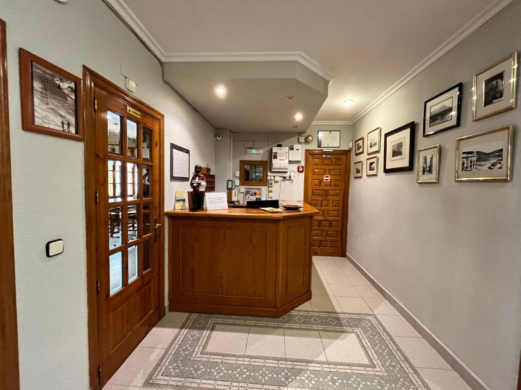 a hallway with a counter in a room with a refrigerator at Meson de Castiello in Castiello de Jaca