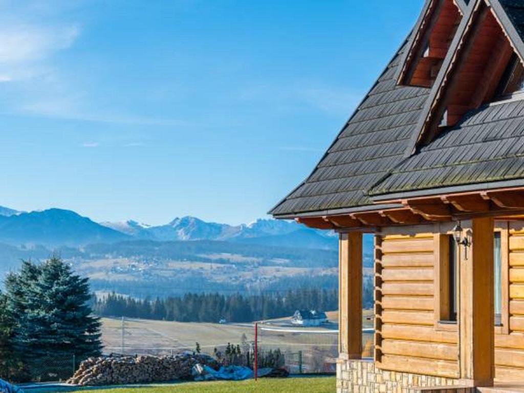 a log cabin with a view of the mountains at Domki u Jasia in Zakopane