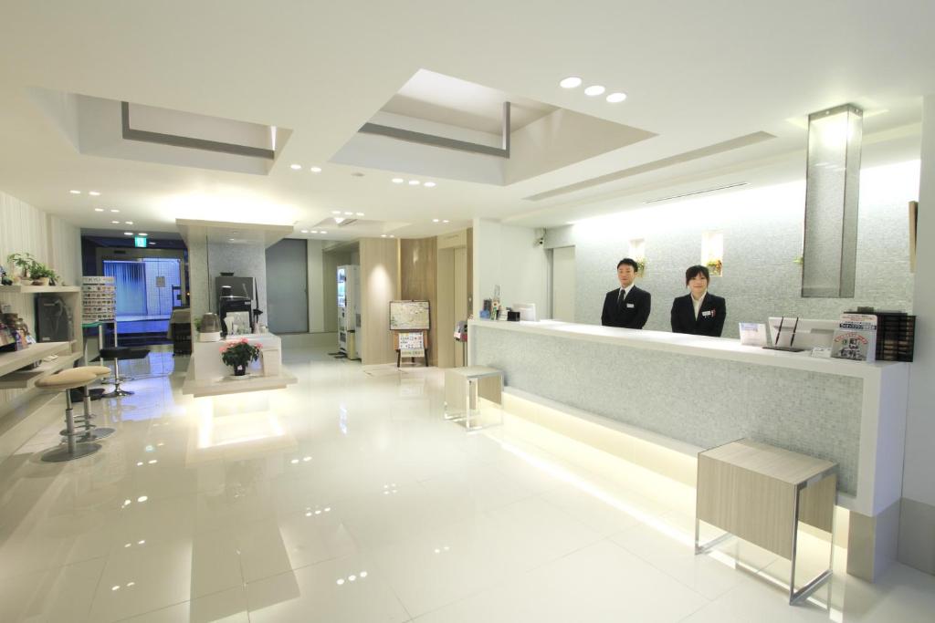 two people standing at a counter in a salon at Ochanomizu Inn in Tokyo