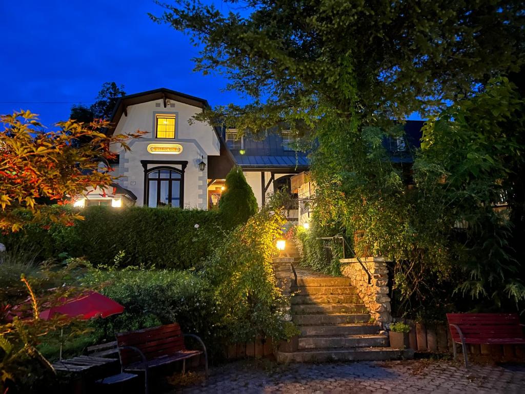 a house with stairs leading up to it at night at Penzión Talisman in Rajecké Teplice