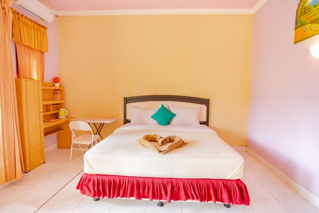 Postel nebo postele na pokoji v ubytování Pondok Guru Bakti Cottage