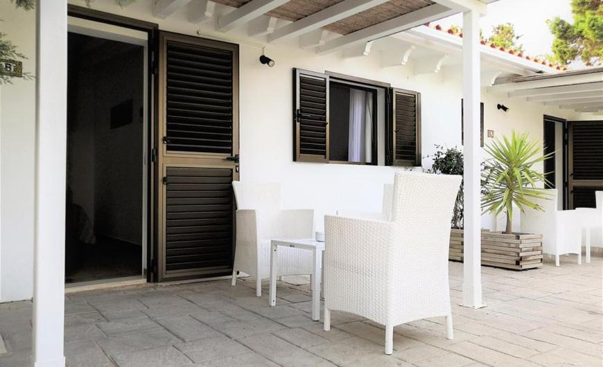a patio with a table and chairs on a house at Hotel Rosamar - Emar Hotels in Es Pujols