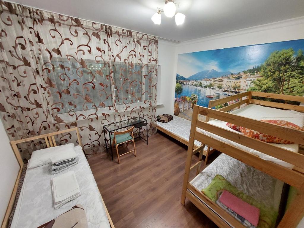 a room with two bunk beds and a mural at The Place Astana Hostel in Astana