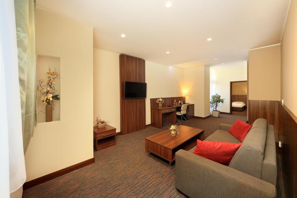 a living room with a couch and a table at Congress Hotel Centrum in Košice