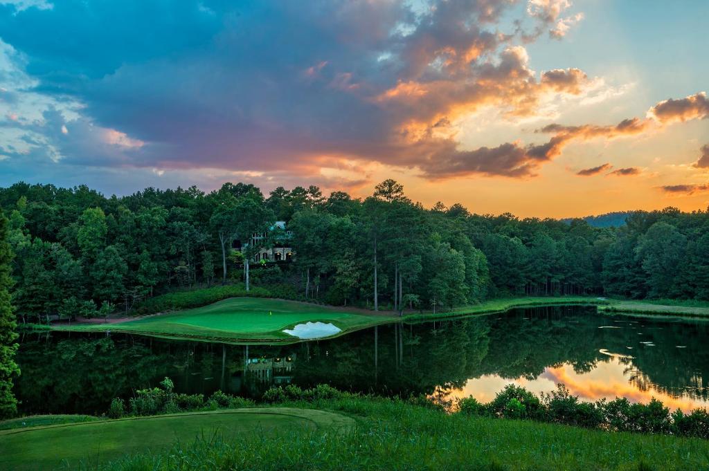 a view of a golf course with a pond at Pursell Farms in Fayetteville