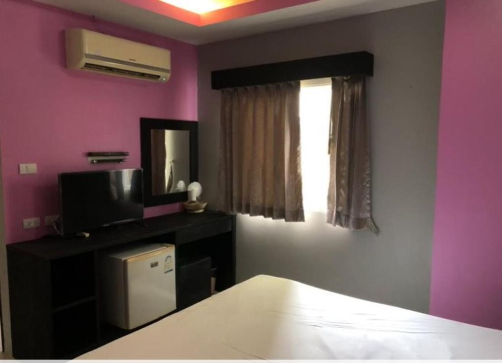 Postel nebo postele na pokoji v ubytování Lavender Patong Hotel