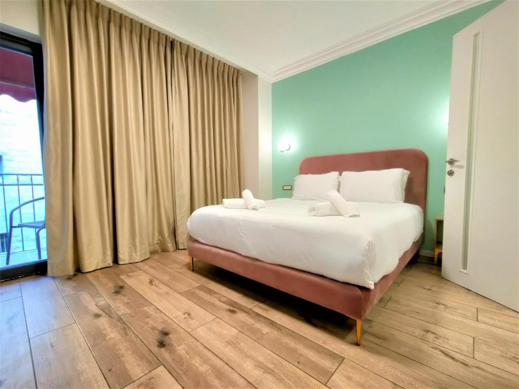 a bedroom with a bed and a dresser at La Perle Hotel in Jerusalem